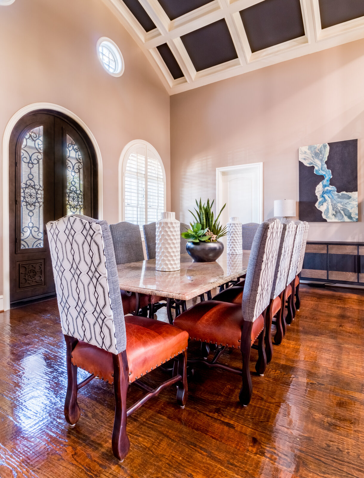 Conference and dining room with stone table and upholstered chairs designed by Landry Designs at the MomentUs Wealth Management office