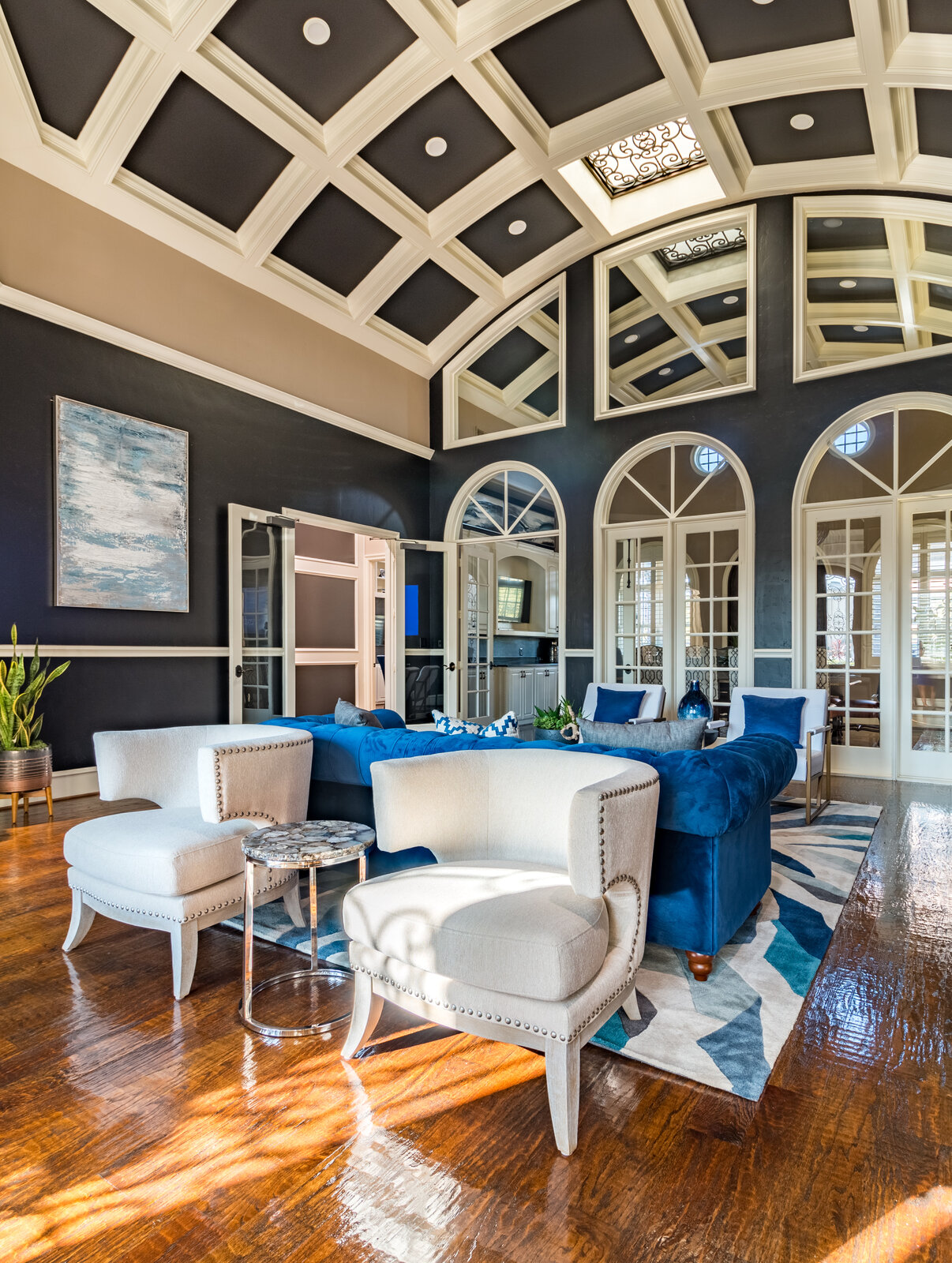 Landry Designs lobby with coffered ceiling, blue velvet seating and arched windows at a Colleyville client's MomentUs Wealth Management office